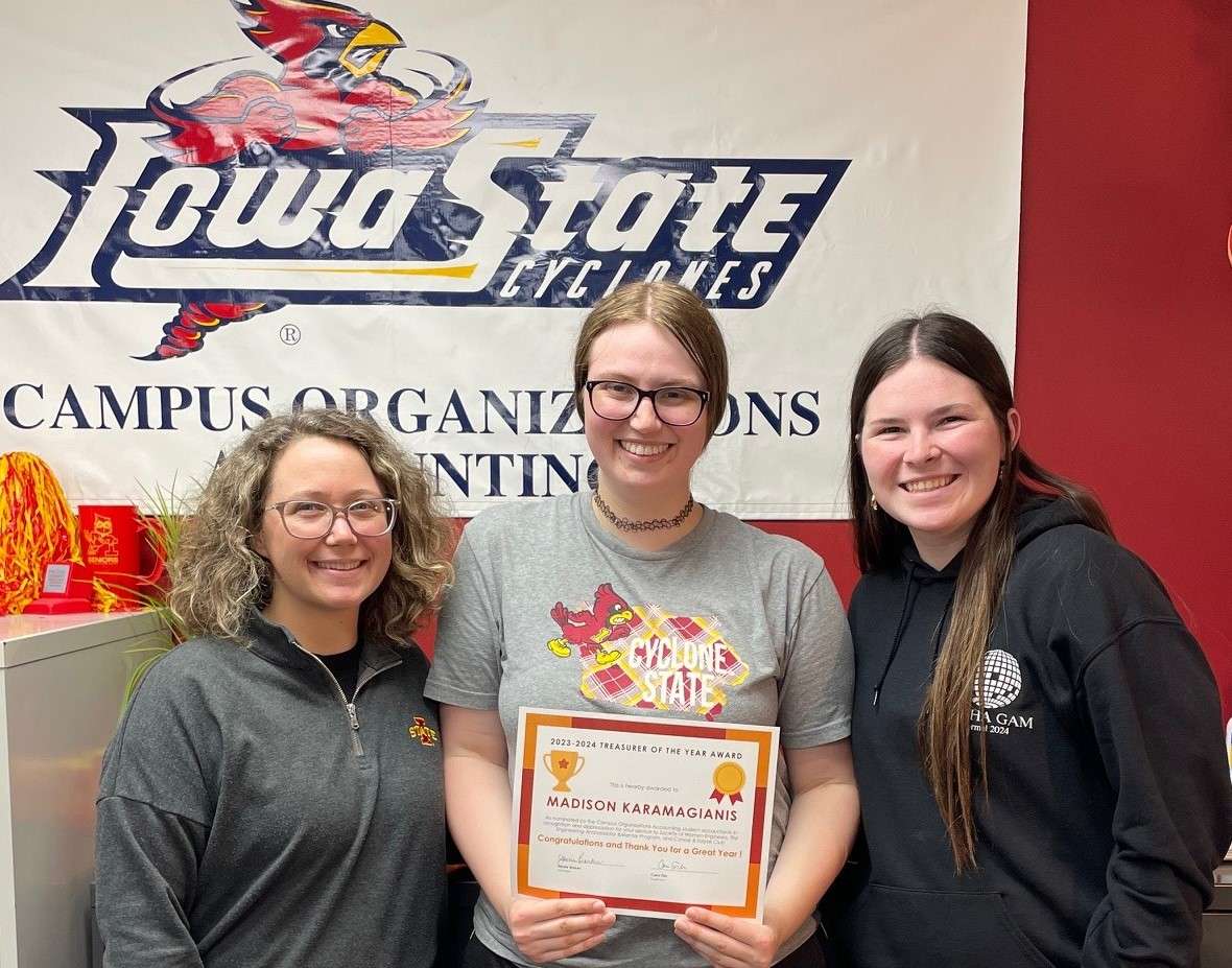 A group of 3 women with Madison Karamagianis, Treasruer of the Year 2024, in the center